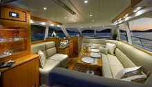 The saloon features a plush L-shaped lounge and dinette