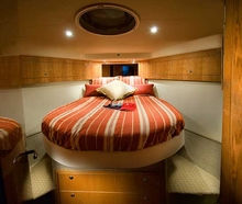 The impressive master stateroom boasts a large island bed, ample storage and feature mirrors