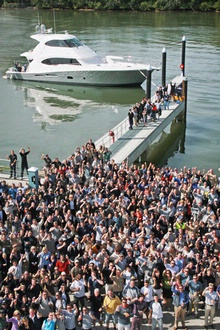 Riviera staff cheer to a successful launch for the new Riviera 70 in the background.