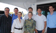 The Mirvac team is shown over a Riviera luxury boat by Riviera’s Scott Cumming (second from right).