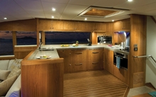 The expansive U-shape galley is fully equipped for gourmet cooking.