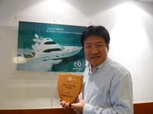 Kingsway Marine owner Leo Wong proudly displays the Asian Dealer of the Year award