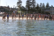 Swimmers line up to start the race at Cottesloe Beach