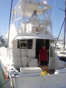 Jeff on the flybridge. Keith Northage previous owner helping to prepare boat and tackle the day before leaving Cairns