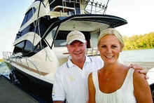 Peter Teakle and his partner Nina Mattingley in front of his Riviera 70 Flybridge 'Born to Battle'