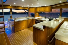 The aft galley is positioned adjacent to the outdoor mezzanine dinning area onboard 'Born to Battle'