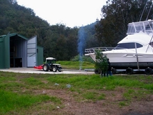 The tractor pulls the 38 back into the shed