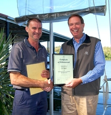 Riviera maintenance manager Darren Miller receives the group award from CEO John Anderson