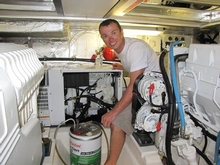 At work, Tim repairing a genset on a Riviera 47