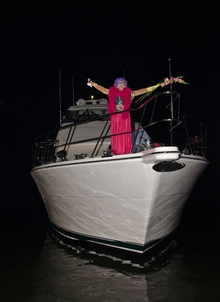 Dame Edna impersonator struck a pose for guests on the bow of the 70