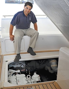 Riviera's Chris Attard inspects the engine bay of a Riviera Sport Yacht