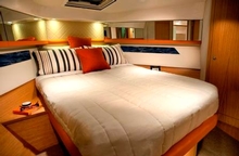 The opulent master stateroom forward has a plush island bed with larger under-bed drawers