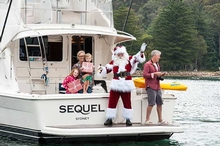 Santa shares some Christmas cheer as he delivers gifts to Riviera owners