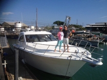 The new owners of the first Riviera 43 Offshore Express shipped to Hawaii stand proudly on her bow